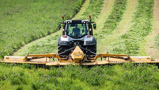 valtra tractor and twintrac on field behind