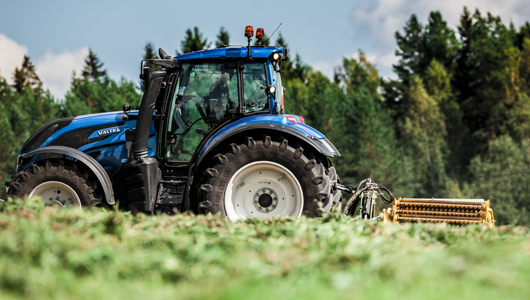 valtra tractor and twintrac on field